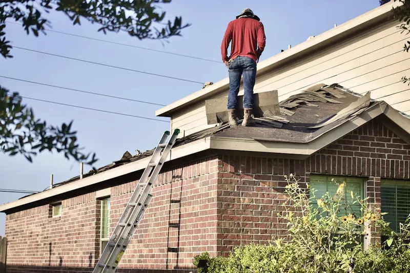 Professional roofer working on a residential roof in Brownwood Acres